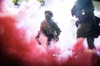 Masks for Federal Agents. AP Photo/Ethan Swope