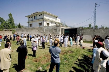 May 1. In this May 3, 2011, file photo local people and media gather outside the perimeter wall and sealed gate of the compound and house, top left, where al-Qaida leader Osama bin Laden was caught and killed in Abbottabad, Pakistan. The hunt for Osama bin Laden took nearly a decade. Bin Laden, who was the mastermind behind the September 11, 2001 attacks on the World Trade Center in New York City, and Pentagon in Arlington, Virgina, was killed by an elite team of Navy SEALs on May 2, 2011.  Credit: AP Photo/Anjum Naveed,