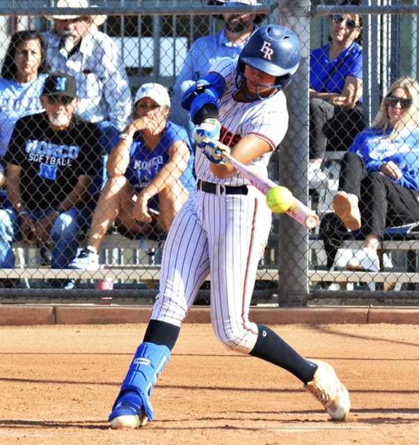 Eastvale Roosevelt’s Aubrey McLaughlin hammers a home run against Norco, accounting for the Mustangs lone run in the Cougars 15 – 1 win. 