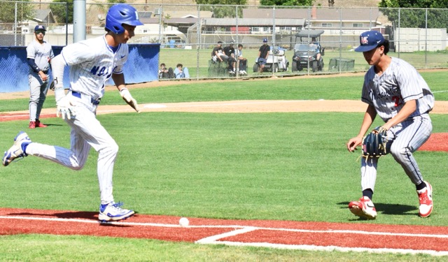 Featured Photos 05-15-2025. Norco’s Zach Fielder (left) races up the first baseline after laying down a perfect bunt as Maranatha pitcher Dylan Hoang waits for the ball to roll foul in vain.