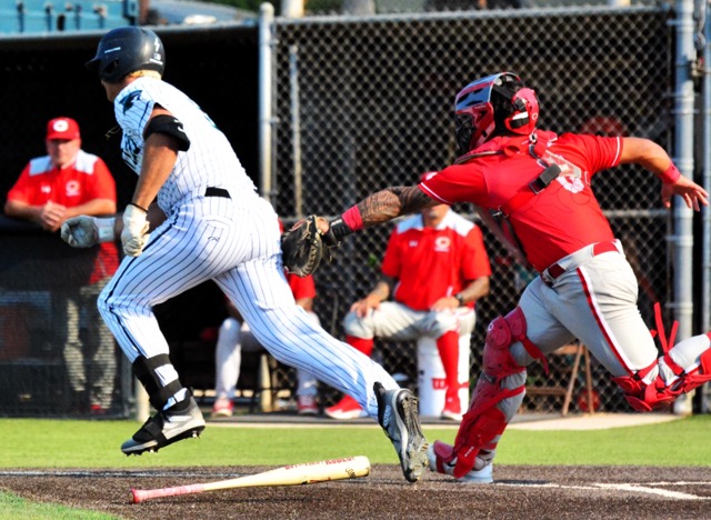 Corona Santiago’s Max Eldridge (left) is tagged out by Corona catcher Jesiah Andrade (right) after a dropped third strike. The Panthers advanced 6–1, eliminating the Sharks in the D1 double-elimination tourney. The Panthers travel to Sherman Oaks today (Friday) to play Notre Dame. The Knights shut out Norco 4-0 in the second round. After topping Ayala in the third round, the Cougars are at Orange Lutheran today.