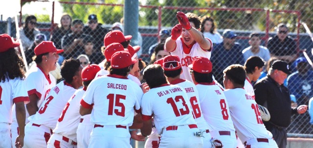 Corona’s Adrian Ruiz is mobbed by his teammates after hitting a three-run home run in the bottom of the fifth against Norco.