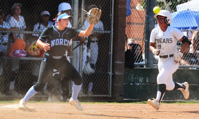 Norco first baseman Savannah Gonzalez (left) waits for a throw from shortstop Leighton Gray to complete a double play as the batter, Riverside Poly’s Violet Espinosa, sprints to first.