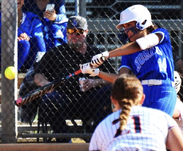 Norco’s Leighton Gray blasts a two-run homer as Mustang third baseman Cali Stewart looks in.