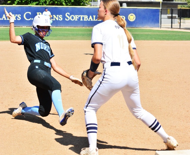 Norco’s Leighton Gray slides into third base while Kelsey Luderer of Notre Dame Sherman Oaks waits for the throw. The Cougars routed the Knights 8 – 0 in the quarter-final game.