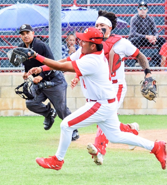 While the umpire and Corona catcher Jesiah Andrade watch, first baseman Matthew Herrera makes a running catch on a bunt attempt by a Fullerton batter. The Panthers won 8 – 1.