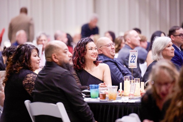 A table full of guests look on