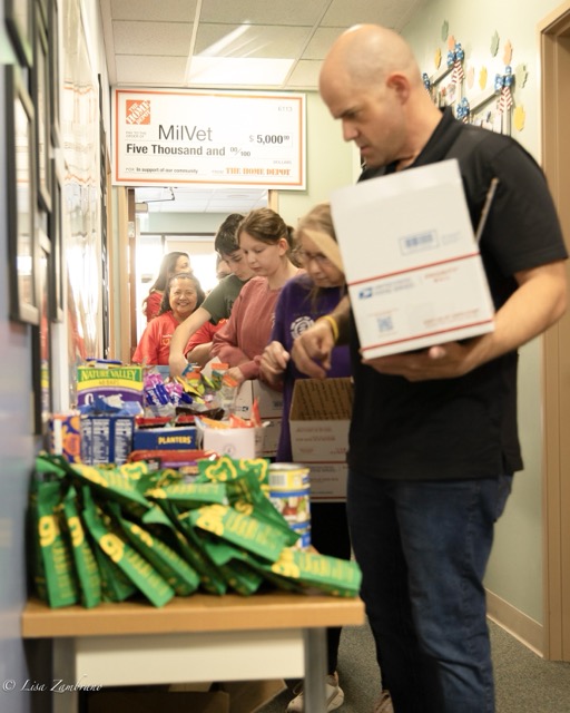 Volunteers lined up around MilVet to collect food and other snacks. Hilden encouraged volunteers to add in a few other items they thought the soldier may enjoy. Credit: Lisa Zambrano