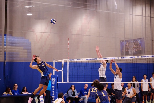 Santa Rosa Academy’s Enakai Dixon (#7) launches a powerful cross-court attack against the Titans' defense. Dixon and the Rangers kept the set close, pushing the top-seeded Titans to a 25-23 finish.