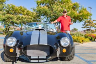 Ernie O’Dell stands with his 1965 Ford Shelby Cobra that he rebuilt with his son at the Menifee Motor Mania, Saturday June 13.