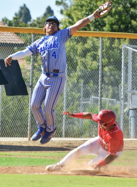 Featured Photos 06-12-2026. San Diego Eastlake’s Jayden Conero (4) leaps high for a throw from the catcher while Corona’s Josiah Andrede (6) slides safely into third during State Regional playoff action.