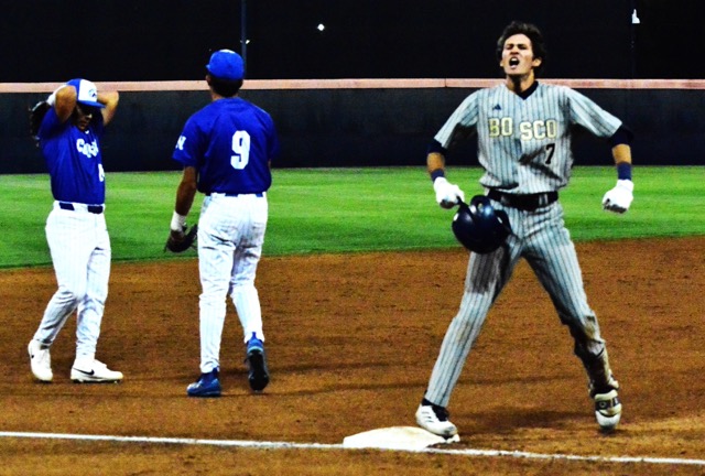 St. John Bosco’s Jack Champlin celebrates at third after he tripled off the left field wall, scoring a run while Norco’s Austin Maltese (left) and Jayden Serna (9) react.   