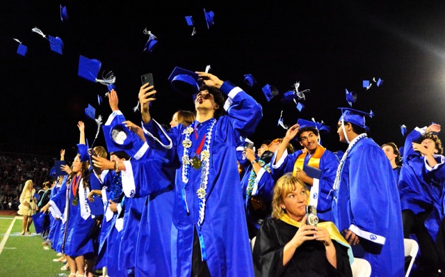  Norco High students, teacher and Mayor Robin Grundmeyer (lower middle) record the festivities as they toss their caps in the air at the end of the 2026 Graduation ceremony Wednesday evening. Additional photo on P16. Photo by Gary Evans