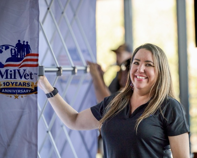 MilVet CEO Raven Hilden smiles as she helps set up for the massive military care package event at Storm Stadium.