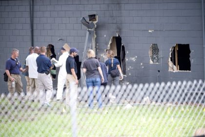 Law enforcement officials investigate the rear of Pulse Orlando after a shooting involving multiple fatalities at the nightclub in Orlando, Fla., Sunday, June 12, 2016. Credit: AP Photo/Phelan M. Ebenhack