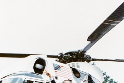 White House Helicopter. President Richard Nixon stands in front of the Sikorsky VH-3A "Sea King" slated for restoration, flashing peace signs, shortly before his resignation became effective, August 9, 1974. White House Photo Office