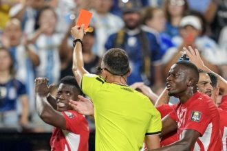 Referee Joao Pinheiro, of Portugal, gives a red card to Switzerland's Breel Embolo (7), left, during the World Cup quarterfinal soccer match between Argentina and Switzerland in Kansas City, Mo., Saturday, July 11, 2026. Credit: AP Photo/Ed Zurga