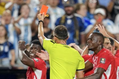 Referee Joao Pinheiro, of Portugal, gives a red card to Switzerland's Breel Embolo (7), left, during the World Cup quarterfinal soccer match between Argentina and Switzerland in Kansas City, Mo., Saturday, July 11, 2026. Credit: AP Photo/Ed Zurga