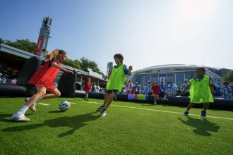 Children wearing shirts of Austria and Argentina play soccer outside the stadium before the World Cup Group J soccer match between Argentina and Austria in Arlington, Texas, near Dallas, Monday, June 22, 2026.  Credit: AP Photo/Julio Cortez