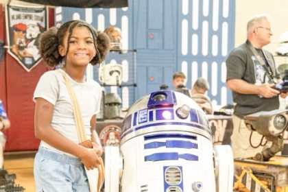 Alana Thomas meets R2D2 at the 4th annual Perris Comic Con Saturday, August 15, at the Bob Glass Gymnasium. The event included costumed attendees competing in a cosplay competition, a Magic the Gathering and Mario Kart Tournament, a performance from a Huntrix (K-Pop Demon Hunter) tribute group, and vendors.