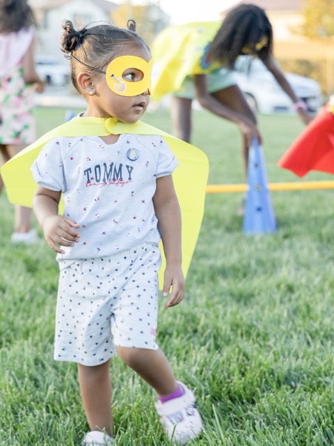 RIGHT: Berline, 3, dressed like a super hero. A supper hero booth, and obstacle course, were set up so kids could live out their superhero dreams.