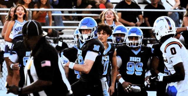 Norco receiver Tegan Ogas (center) eyes Eastvale Roosevelt defender Xavier Marshall (0) after making an incredible one-handed catch and run for a long gain in the first quarter.