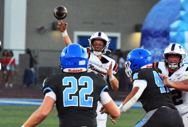 Eastvale Roosevelt quarterback Charlie Bohmer (18) fires a pass while Norco’s Austin Williams (22) defends and Jaden Currin (41) rushes Bohmer. The Cougars topped the Mustangs 55 – 14 in the 2026 season opener at Norco High.