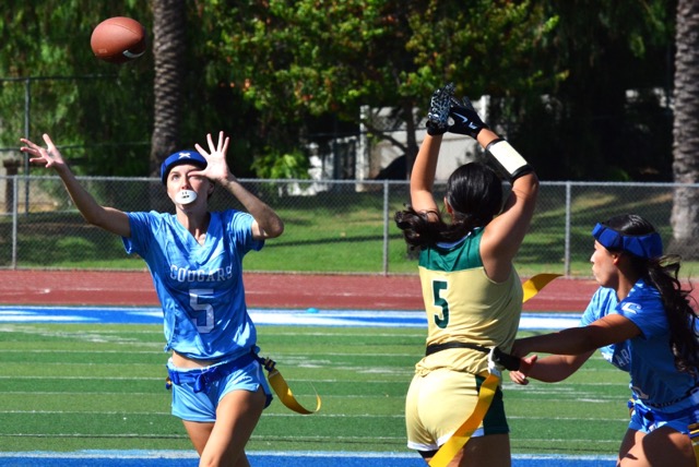 Norco’s Hayden Bolle (5) eyes an interception that bounced off Lakeside receiver Karina Hernandez (5).  Bolle grabbed the deflection and ran it back for a pick 6 helping the Cougars blank the Lancers 41 – 0.