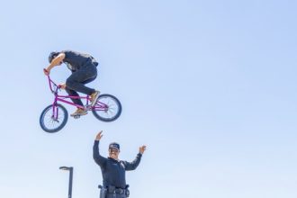 A BMX rider Jumps over Officer Torres from the Val Verde District Police Department Credit: Lisa Zambrano