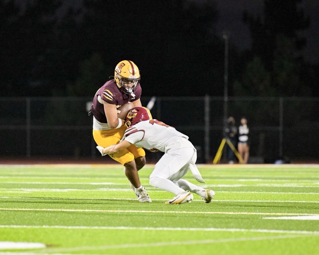 A Colton Defender wraps up Arlington’s running back in the open field