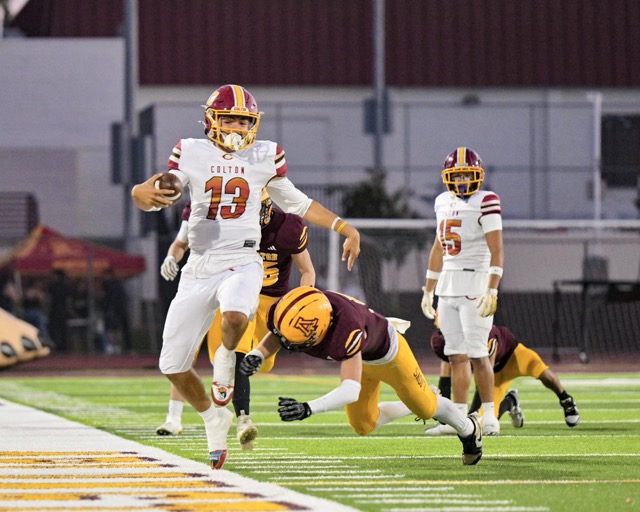 Colton Quarterback Koa Regalado #13, scrambles outside the box for a 10-yard gain, hurdling over an Arlington defender.