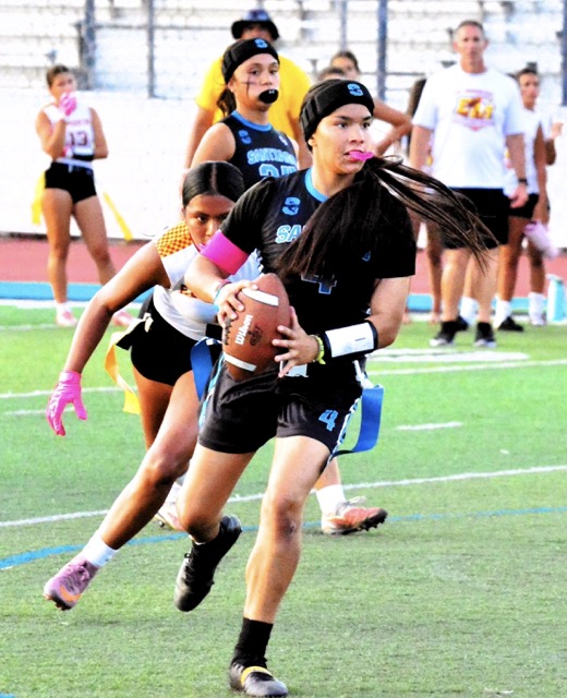 Featured Photos 09-04-2026. Santiago QB Priscilla Hernandez (4) is about to launch a touchdown pass to a wide-open Gracie Weinrich in the end zone while Shark teammate Kianne Rubalcava watches from behind.