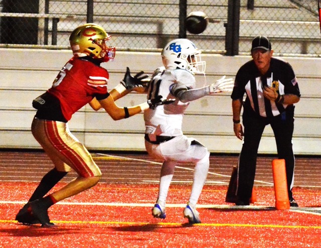 Corona’s Nico Mejia (5) gets ready to catch a touchdown pass after San Gorgonio defender Aaden Rojas (11) deflected the toss right to Mejia under the watchful eye of the referee. The Panthers blanked the Spartans 49 – 0.