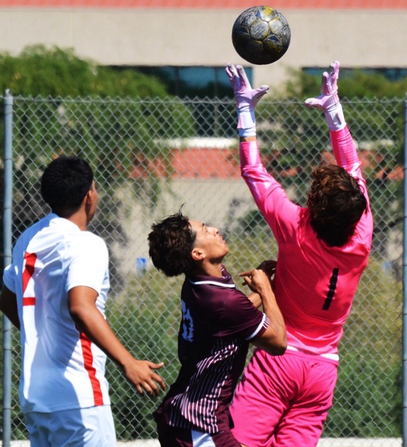 Norco’s Diego Alcaraz (27) pushes Long Beach goalie Fabio Ardizzoia (1) while fighting for the ball, as Nikolas Huebel (2) watches. The Mustangs beat the Vikings 2 - 1.