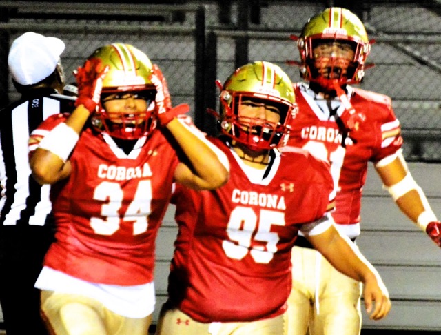 Corona linebacker Boaz Castillo (34) reacts after intercepting a pass and returning it 30 yards for a pick-six.