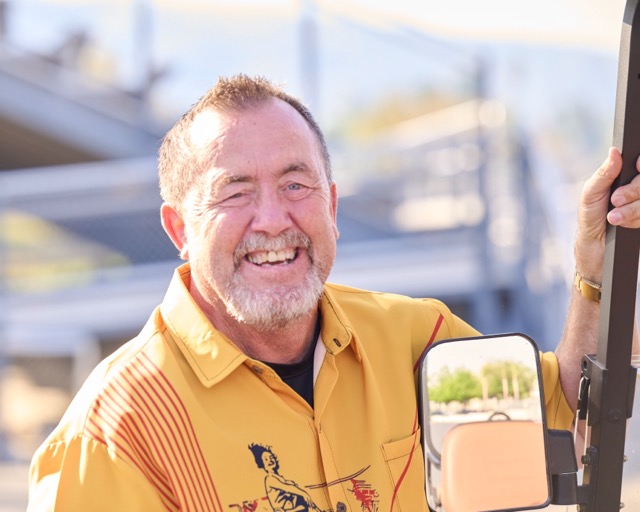 Lakeside High School Assistant Principal and Athletic Director, Scott Lawson, flashes a smile from a golf cart during the Lancers’ nonleague girls’ flag football matchup
