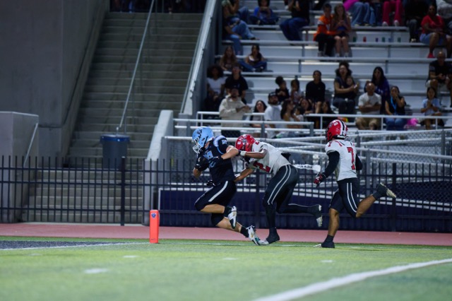 Liberty’s Nate Levine #88, fights through contact near the front corner of the end zone for a touchdown