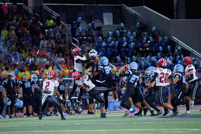 Liberty players battle Elsinore for possession of an onside kick before the Bison recover the football