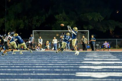 Vista Murrieta’s wide receiver, Shane Granger #7, reaches for a pass on the outside while Centennial defenders close in. The Centennial Huskies defeated the Vista Murrieta Bronco's 65-14 in the league opener.