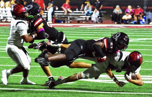 Corona Centennial’s Mekhi Kennedy (27) levels Murrieta Valley running back Ryder Lopez (bottom) while Tahj Stephens (left) and Koti Fultz (center) collide. The Huskies defeated the Nighthawks 42-20.