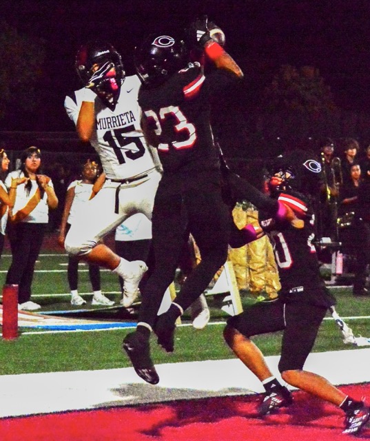 Murrieta Valley receiver Mikey Medina (15) was reaching for a touchdown catch from QB Ty Isaia, but Corona Centennial’s Andre Pommells (23) deflected the pass in the end zone.
