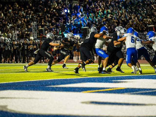 Chapparal’s Running Back (15) Talen Ritayik, takes a handoff up the middle between defenders for a touchdown against Norco.