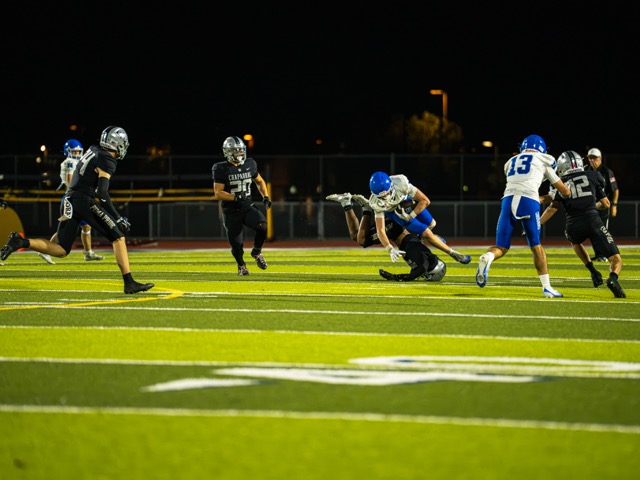 Norco’s Tegan Ogas (18), hauls in a reception before taking a hard hit from a Chaparral defender.