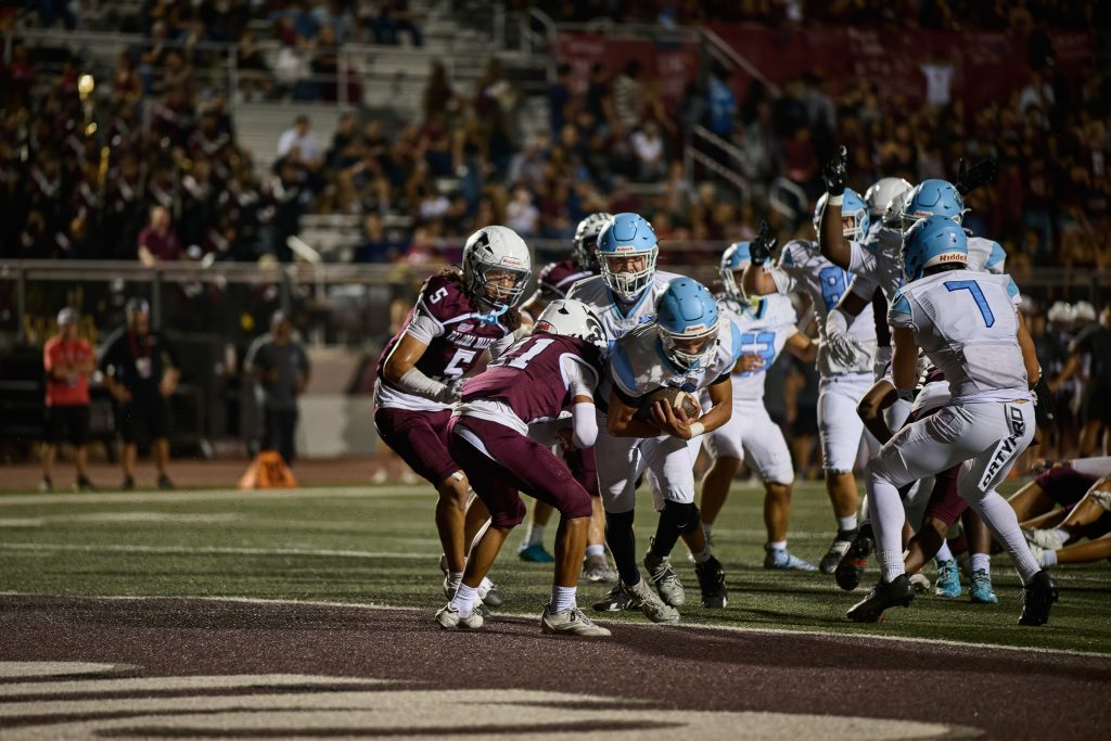 Liberty’s RB, Nathan Ayala #12, powers through Paloma Valley defenders and crosses the goal line for a touchdown