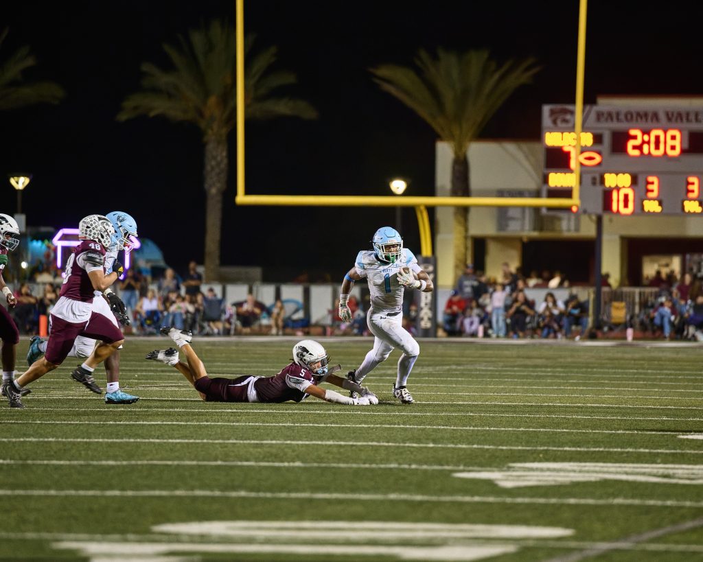 Liberty’s Christopher Debose (#1) escapes the reach of Paloma Valley’s Levi Laban (#5) to gain a handful of yards.