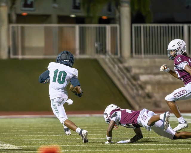 Perris’s Kaizer Daniels (#10) escapes a diving tackle to gain a handful of yards on a short pass before getting out of bounds