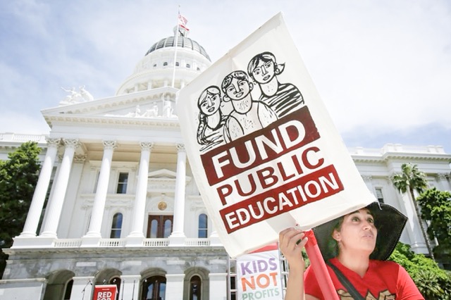 Tax Measures. Mayra Joseph, a teacher at Sylvia Mendez Elementary School in Berkeley, joined members of the California Teachers Association and supporters of public education in a march to the Capitol as part of RedForEd Day of Action in Sacramento on May 22, 2019.  Credit: Photo by Rich Pedroncelli, AP Photo