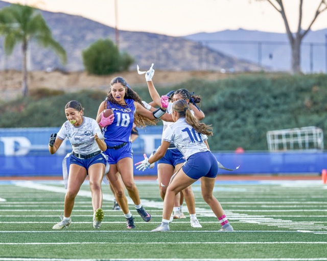 Temescal Canyon’s Leila Ortiz (#18) fights forward into a swarm of Jurupa Valley defenders before her flag is pulled.